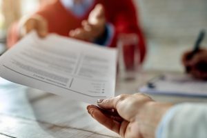 closeup-job-applicant-giving-his-resume-job-interview-office_637285-6917
