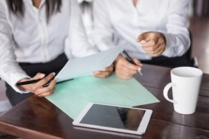 closeup-two-female-colleagues-working-with-documents-table_1262-12287-2