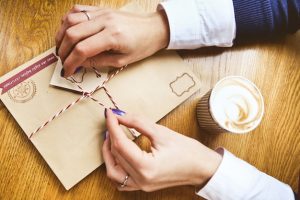 festive-decoration-with-women-s-hands-new-year-s-letter-envelope-glass_8353-6136