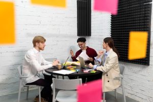 full-shot-colleagues-sitting-table_23-2149362921