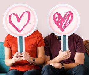 happy-couple-holding-heart-signs_53876-42602