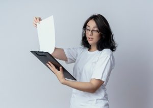 impressed-young-pretty-caucasian-girl-wearing-glasses-holding-looking-clipboard-isolated-white-background-with-copy-space_141793-90480