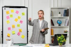 marketing-young-pretty-cute-business-lady-grey-blazer-office-pointing-team-member_140725-165646