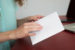 side-view-woman-holding-envelope_23-2149887846