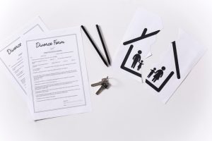 top-view-house-keys-with-divorce-forms-table_23-2148548593