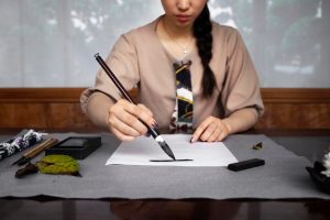 woman-practicing-japanese-handwriting_23-2149124153-2